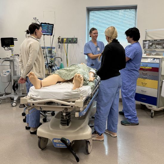 Medical students learning a procedure at the Center for Patient Simulation